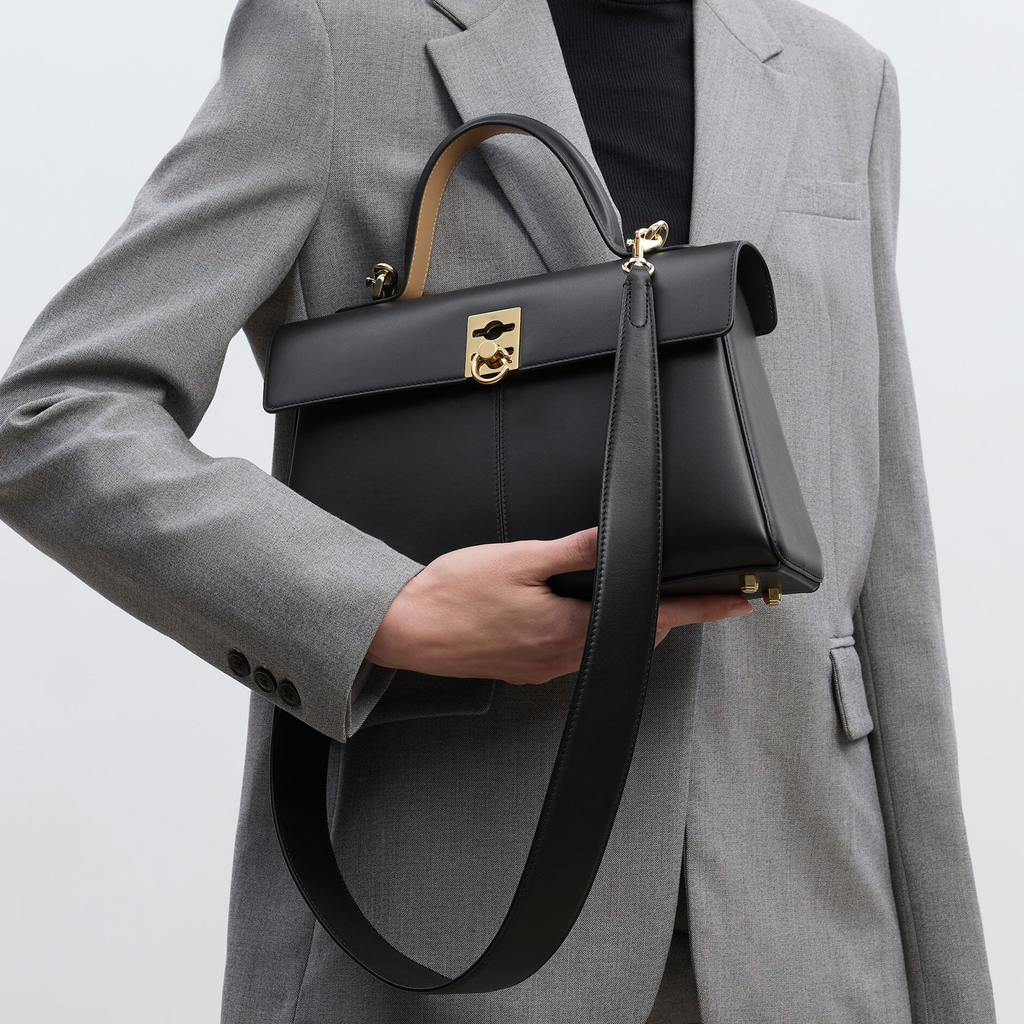 Sleek Solid Black Sharp Trapezoid Vintage Satchel With Distinctive Square Golden Clasp And Rear Full Length Zippered Compartment